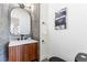 Well-decorated half bathroom with a unique mirror, stylish vanity, and modern fixtures at 8369 W Fairview Ave, Littleton, CO 80128