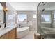 An elegant primary bathroom showcases a freestanding tub, and a glass enclosed shower at 8369 W Fairview Ave, Littleton, CO 80128