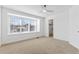 Bright bedroom with a large window, neutral carpet, and a view into the walk-in closet at 8369 W Fairview Ave, Littleton, CO 80128