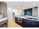 Stylish kitchen island featuring dark cabinetry, a built-in microwave, and sleek countertops at 8369 W Fairview Ave, Littleton, CO 80128