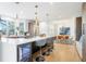 Spacious kitchen with a large island featuring seating and modern pendant lighting, perfect for entertaining at 8369 W Fairview Ave, Littleton, CO 80128