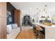 Open concept kitchen featuring a breakfast bar with seating, a sleek design, and modern finishes at 8369 W Fairview Ave, Littleton, CO 80128