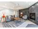 Stylish basement living room with a cozy fireplace, plush seating, and modern décor at 8369 W Fairview Ave, Littleton, CO 80128