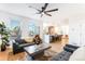 Open-concept living room with modern decor, a stylish kitchen, and hardwood floors for a spacious feel at 8369 W Fairview Ave, Littleton, CO 80128