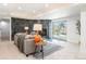 Basement living room boasts a sleek fireplace, modern lighting, and sliding glass doors at 8369 W Fairview Ave, Littleton, CO 80128
