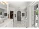 Spacious bathroom featuring a walk-in closet, a marble-clad shower, and double sinks at 1991 E Alameda Ave # 14, Denver, CO 80209