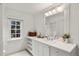 Classic bathroom with white vanity, tiled countertop, and built-in shelving at 1991 E Alameda Ave # 14, Denver, CO 80209