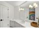 A stylish bathroom featuring marble counters, a large mirror, and a fun rainbow design at 1991 E Alameda Ave # 14, Denver, CO 80209
