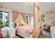 Charming bedroom with floral wallpaper, canopy bed, and abundant natural light at 1991 E Alameda Ave # 14, Denver, CO 80209