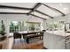 Dining room with exposed beams, modern lighting, and floor to ceiling doors at 1991 E Alameda Ave # 14, Denver, CO 80209