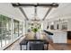Open floor plan dining room featuring exposed beams and backyard view at 1991 E Alameda Ave # 14, Denver, CO 80209