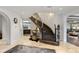 Elegant foyer with curved staircase and stone tile flooring at 1991 E Alameda Ave # 14, Denver, CO 80209