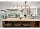 Modern kitchen with white cabinets, marble countertops, large center island with seating, and stainless steel appliances at 1991 E Alameda Ave # 14, Denver, CO 80209