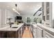 Modern kitchen with white cabinets, stainless steel appliances, large islands, and an open floor plan at 1991 E Alameda Ave # 14, Denver, CO 80209