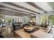 Spacious living room with exposed beams, hardwood floors, comfortable seating, and an open floor plan at 1991 E Alameda Ave # 14, Denver, CO 80209