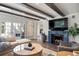 Cozy living room with fireplace, hardwood floors, comfortable seating, and an open floor plan leading to other spaces at 1991 E Alameda Ave # 14, Denver, CO 80209