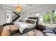 Sun-drenched main bedroom features stylish chandelier, coffered ceilings, oversized windows and a luxurious ensuite bath at 1991 E Alameda Ave # 14, Denver, CO 80209