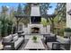 Cozy outdoor living space with a stone fireplace, mounted television, and comfortable seating area with a stylish rug at 1991 E Alameda Ave # 14, Denver, CO 80209