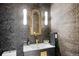 Stylish powder room features designer wallpaper, a modern vanity, and decorative gold-tone accents at 1991 E Alameda Ave # 14, Denver, CO 80209