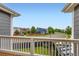 Scenic balcony view overlooking the street, showcasing neighborhood homes on a clear day at 3597 Xanthia St, Denver, CO 80238