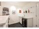 Finished basement bar featuring a wine fridge, sink, and decorative shelving at 3597 Xanthia St, Denver, CO 80238
