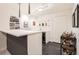 Finished basement bar area with counter seating, wine fridge, and stylish decor at 3597 Xanthia St, Denver, CO 80238