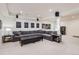Finished basement with large sectional sofa, ottoman, and built-in speaker system at 3597 Xanthia St, Denver, CO 80238