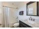Cozy bathroom with tub/shower, marble vanity, and stylish mirror at 3597 Xanthia St, Denver, CO 80238