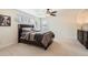 Bedroom featuring neutral walls, plush carpet, a ceiling fan and a dark wood bed frame at 3597 Xanthia St, Denver, CO 80238