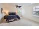Bedroom with modern platform bed, carpet, and large windows providing natural light at 3597 Xanthia St, Denver, CO 80238