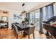 Elegant dining room with stylish furniture, large windows and a sliding door to the patio at 3597 Xanthia St, Denver, CO 80238