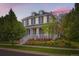Beautiful home with a covered front porch, accentuated by vibrant landscaping at 3597 Xanthia St, Denver, CO 80238