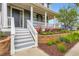 Inviting front porch featuring elegant columns and attractive flowerbeds and ADT security at 3597 Xanthia St, Denver, CO 80238