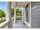 Covered front porch showcasing stylish flooring and views of the surrounding neighborhood at 3597 Xanthia St, Denver, CO 80238