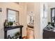 Charming hallway with decorative mirror and view into a bright, stylishly decorated bedroom at 3597 Xanthia St, Denver, CO 80238