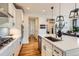 Bright kitchen features white cabinets, stainless steel appliances and a large island at 3597 Xanthia St, Denver, CO 80238