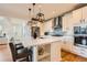 Modern kitchen featuring an island with bar seating, stainless steel appliances, and custom cabinets at 3597 Xanthia St, Denver, CO 80238