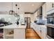 A stylish kitchen equipped with stainless steel appliances and white cabinets offering ample storage at 3597 Xanthia St, Denver, CO 80238