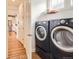 Convenient laundry room with full-size washer and dryer and storage shelving at 3597 Xanthia St, Denver, CO 80238