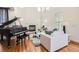 Bright living room with hardwood floors, fireplace, and grand piano at 3597 Xanthia St, Denver, CO 80238