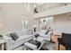 Bright living room showcasing hardwood floors, white sofas, and fireplace at 3597 Xanthia St, Denver, CO 80238