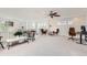 Open loft featuring multiple sitting areas, neutral carpet, and a ceiling fan at 3597 Xanthia St, Denver, CO 80238