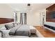 Bright bedroom with a king bed, natural light and a view into an en-suite bathroom at 3597 Xanthia St, Denver, CO 80238