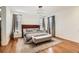 Relaxing main bedroom suite featuring neutral colors, a king-size bed, and modern light fixture at 3597 Xanthia St, Denver, CO 80238