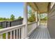 Inviting porch with classic columns and gray flooring, offering a cozy outdoor space at 3597 Xanthia St, Denver, CO 80238