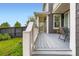 Charming side porch with seating area, enhanced by gray composite decking at 3597 Xanthia St, Denver, CO 80238