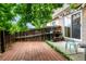 Cozy back yard with wood deck, patio space, a garden shelf, and partial privacy fence at 4636 S Dillon Ct # B, Aurora, CO 80015