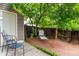 Charming back yard retreat with wooden deck, mature tree, storage shed, and lounging area at 4636 S Dillon Ct # B, Aurora, CO 80015