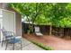 Charming back yard retreat with wooden deck, mature tree, storage shed, and lounging area at 4636 S Dillon Ct # B, Aurora, CO 80015