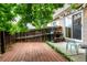 Cozy back yard with wood deck, patio space, a garden shelf, and partial privacy fence at 4636 S Dillon Ct # B, Aurora, CO 80015